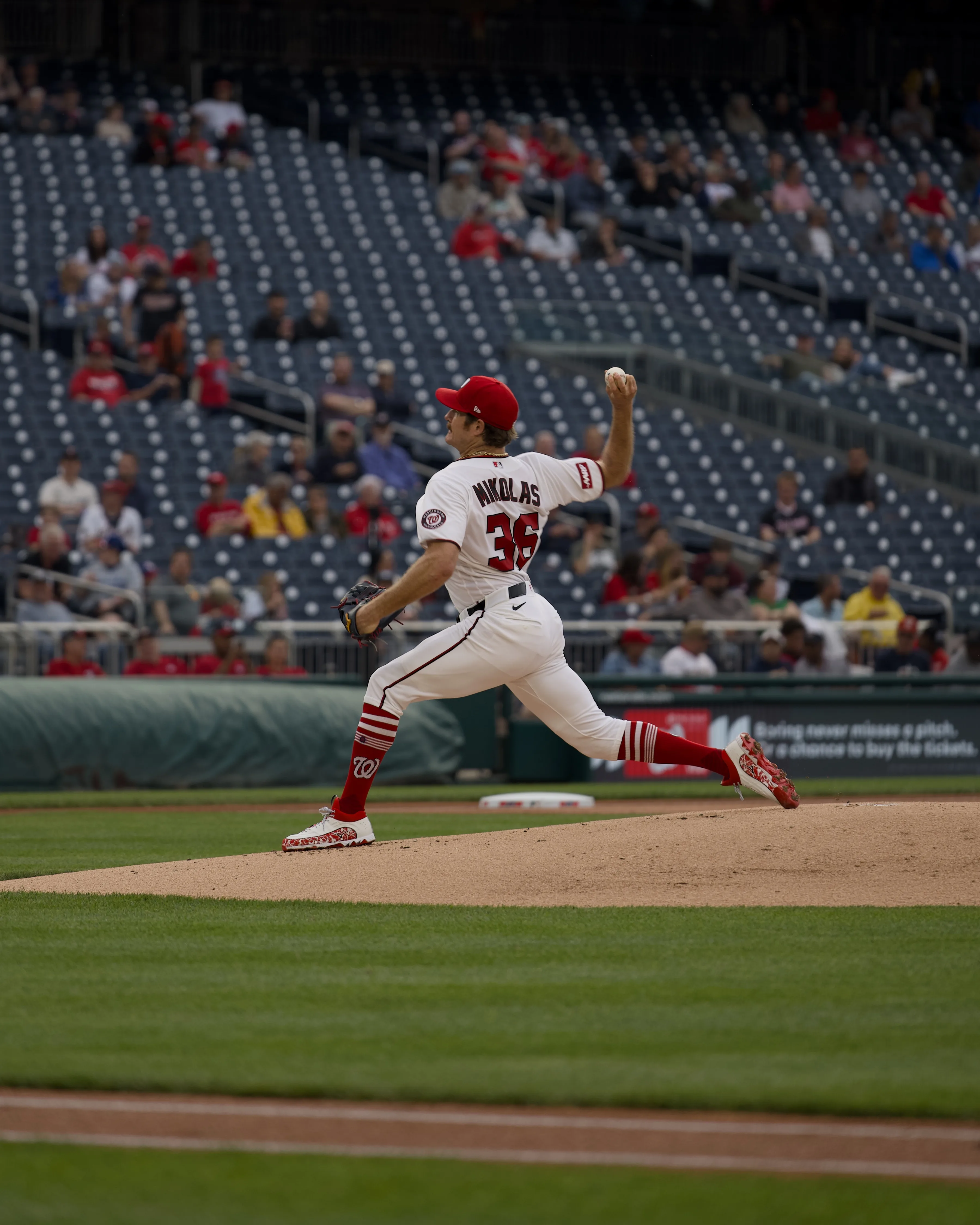 Washington Nationals pitcher Nikolas #36 in full wind-up on the mound in a white home uniform