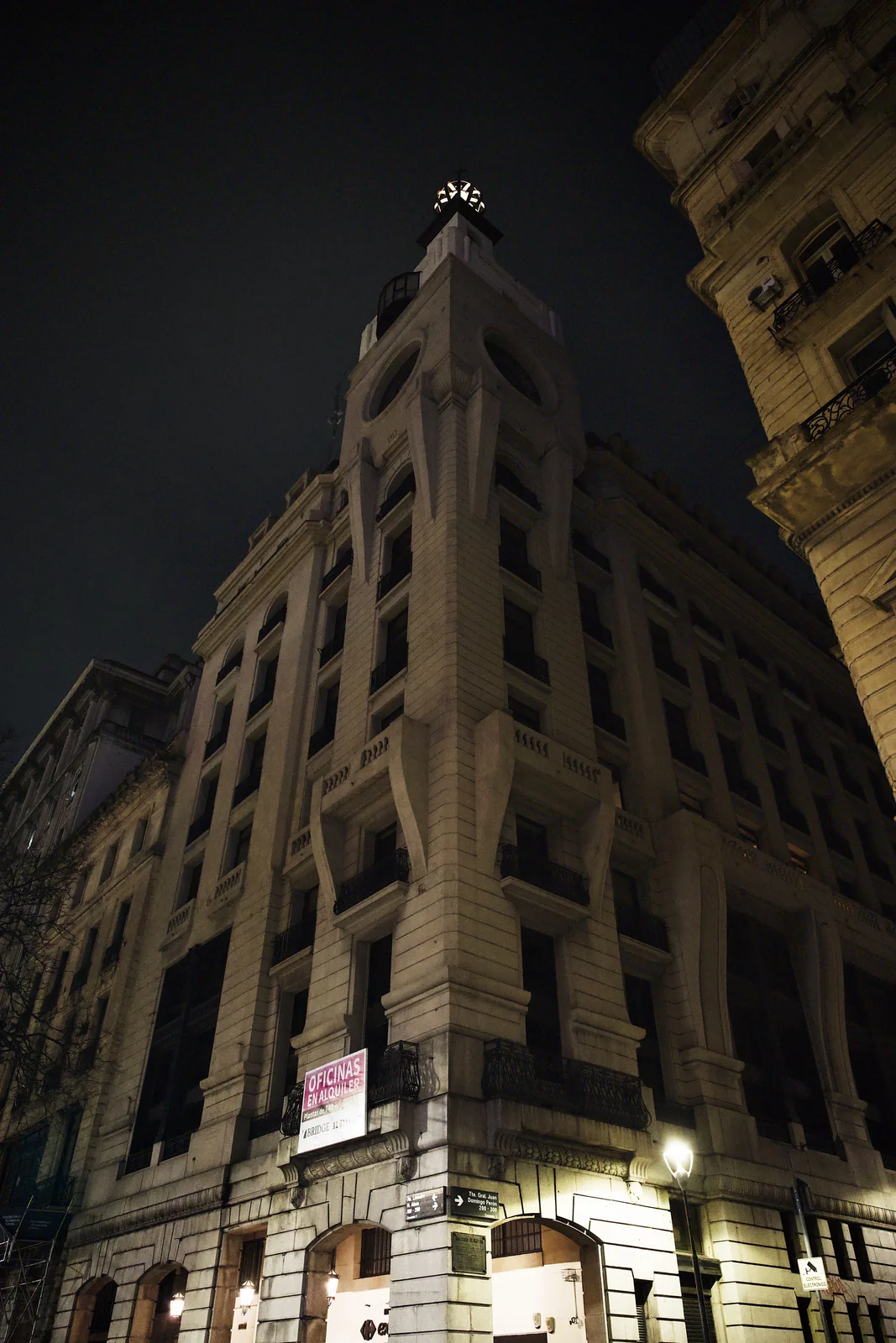 Historic ornate building corner lit dramatically at night in downtown Buenos Aires